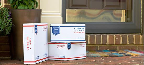 Boxes outside a residence for USPS package pickup.